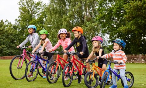 Group photo of six children of different ages on Bike Club bikes ranging from balance bike through to larger 26" wheel bike. All available to lease or rent on a long term susbscription