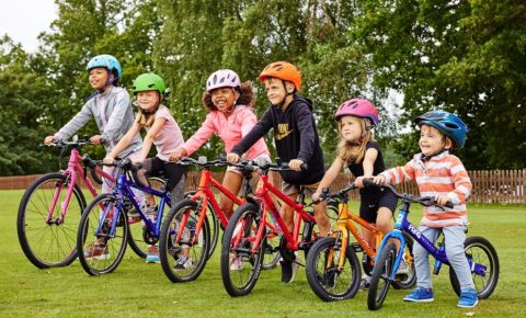 Group photo of children riding bike club bikes