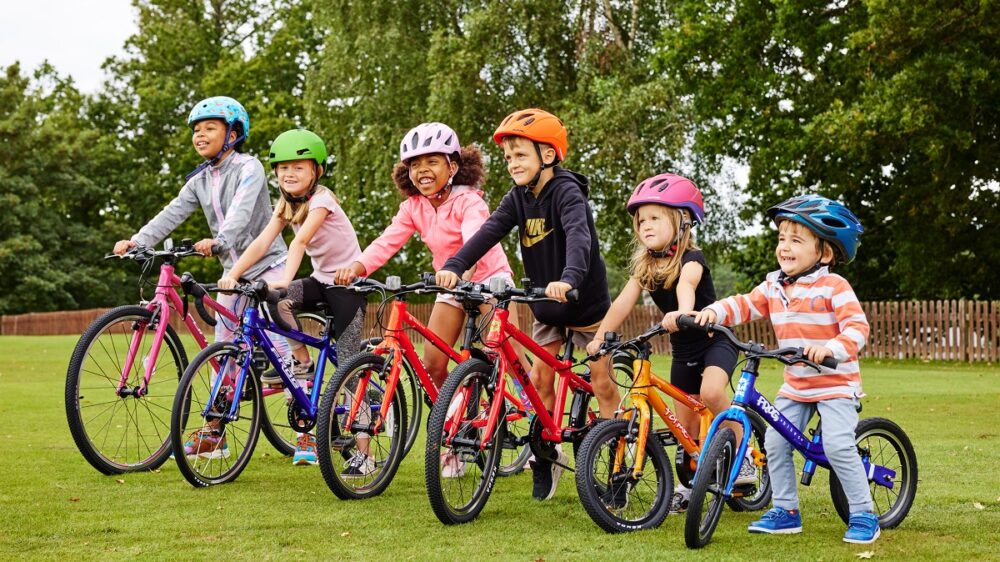 Group photo of children riding bike club bikes