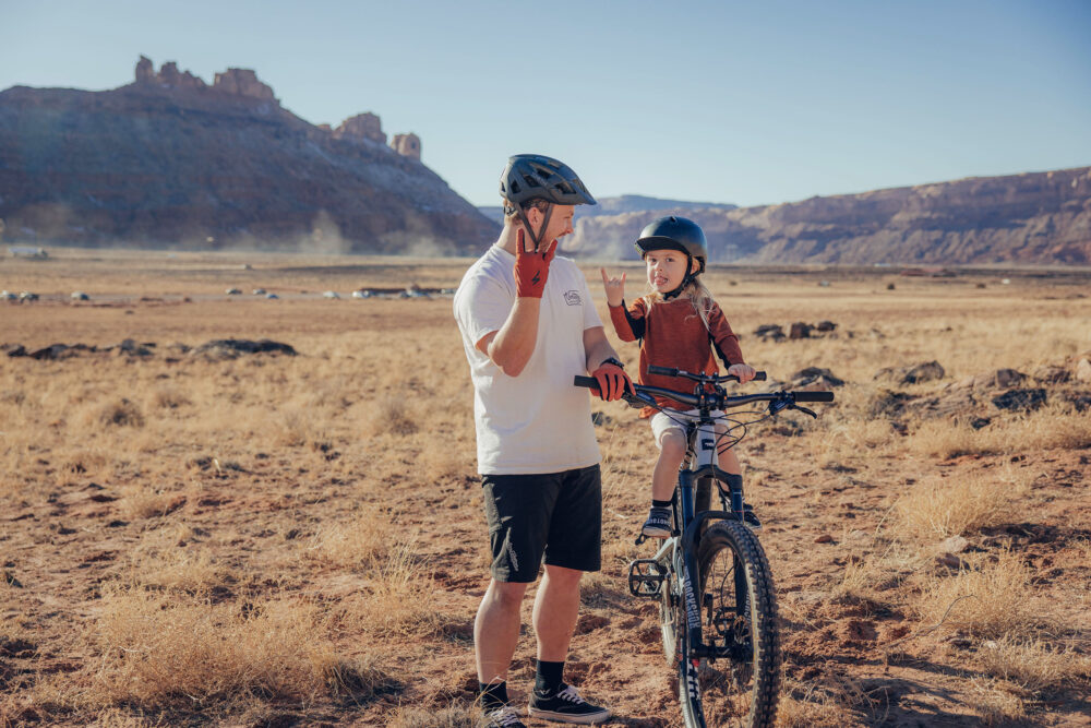 mountain bike parent with toddler on front seat handlebars