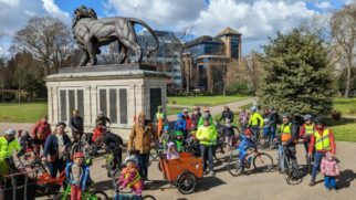 Kidical Mass in Reading UK - riders gather at the start of the ride with their bikes in front of a statue