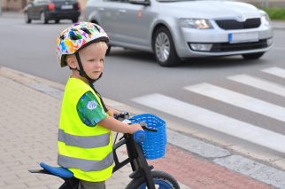 Little boy balance biking to school