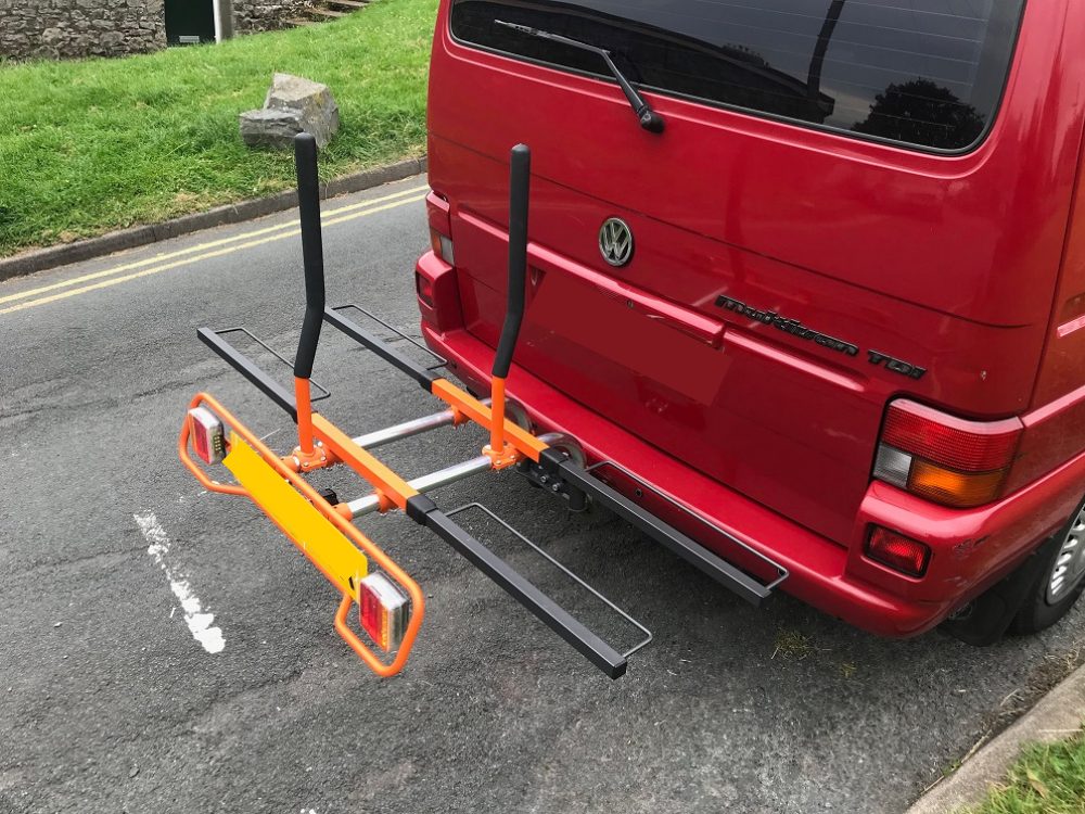 Photo of the Pendle Bike Race we've been sent to review attached to a red van. There are no bikes in the rack, so you can see the support mounts and the carry racks in situ