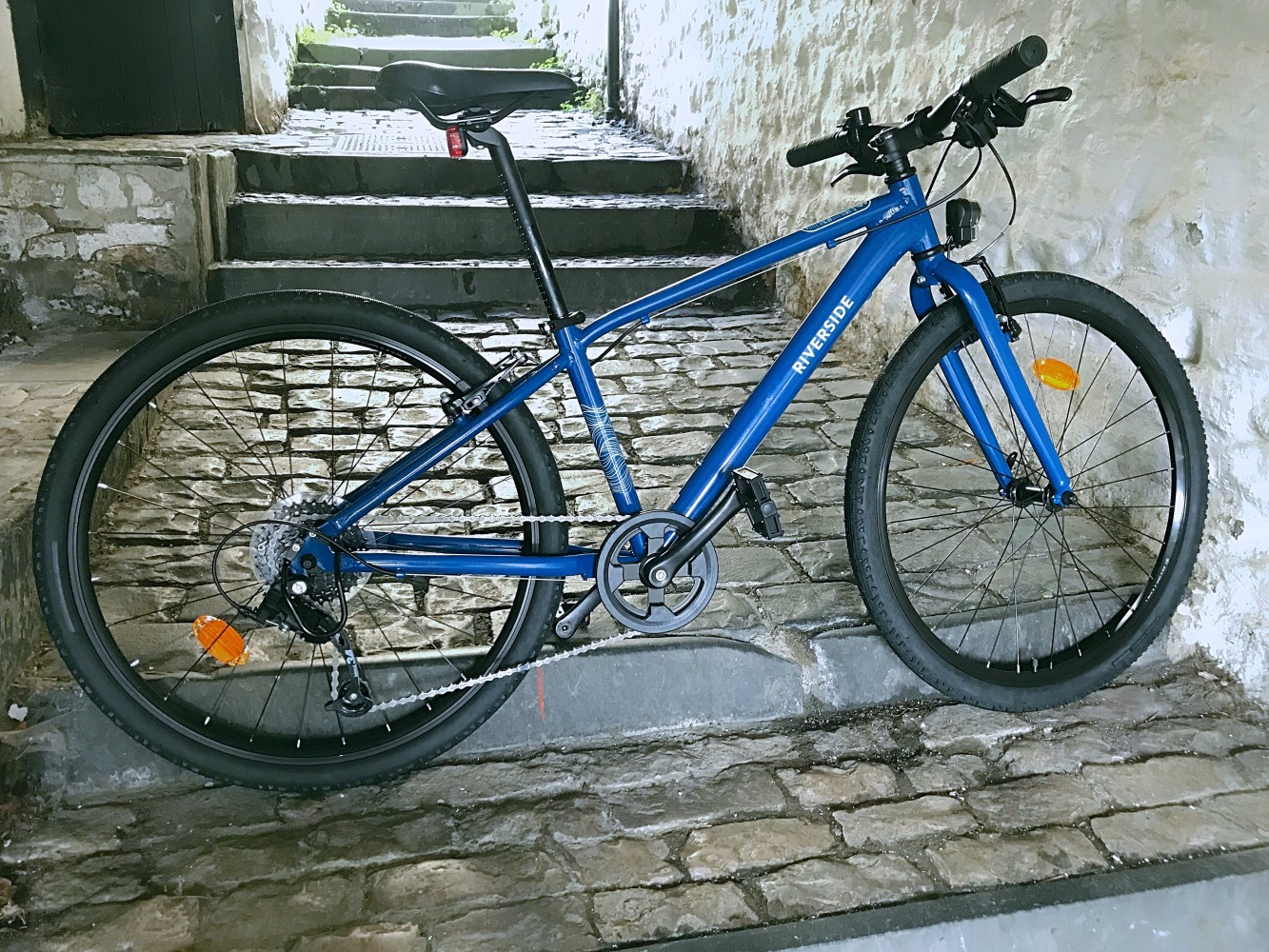 BTwin Riverside 900 26 inch wheel hybrid photographed in an old cobbled passageway