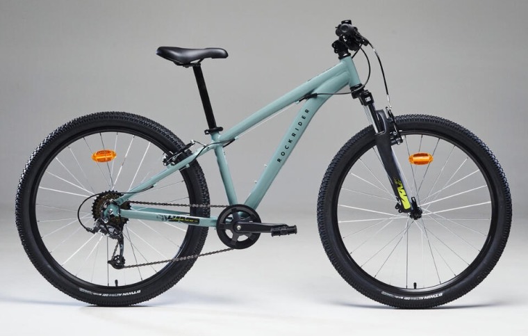 Best kids' bikes: The B'Twin Rockrider in grey, in front of a plain background