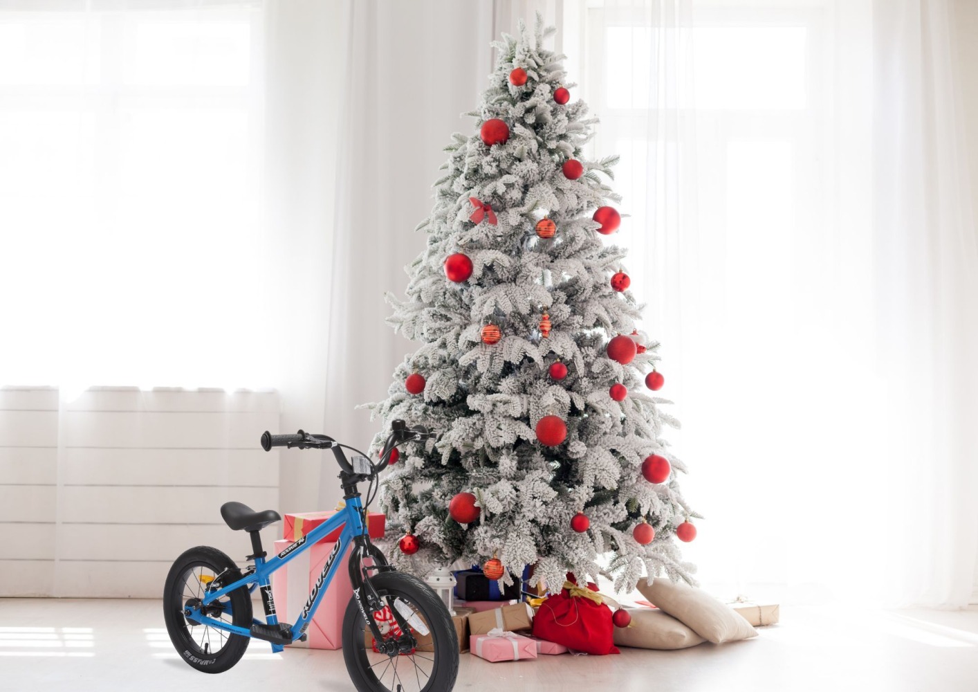 kidvelo blue bike in front of a christmas tree