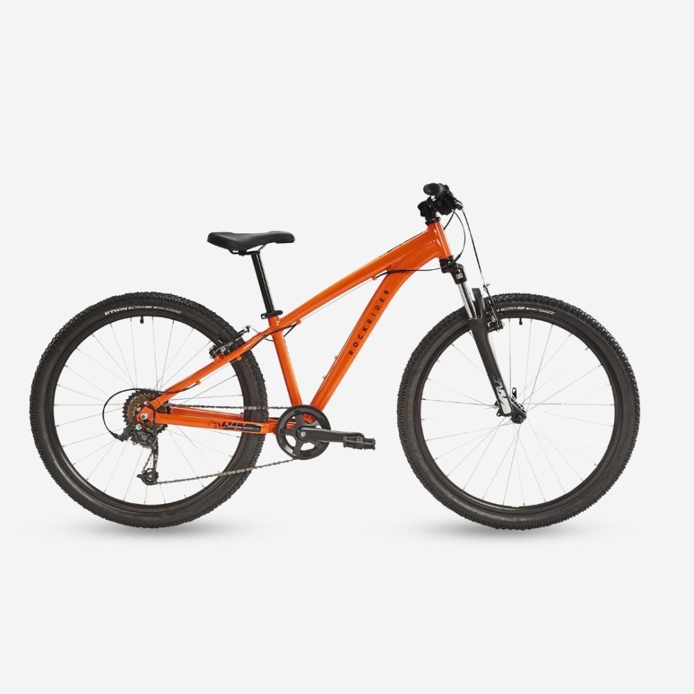 Best 26" kids' bikes: An orange B’Twin Rockrider ST500 mountain bike on a plain background