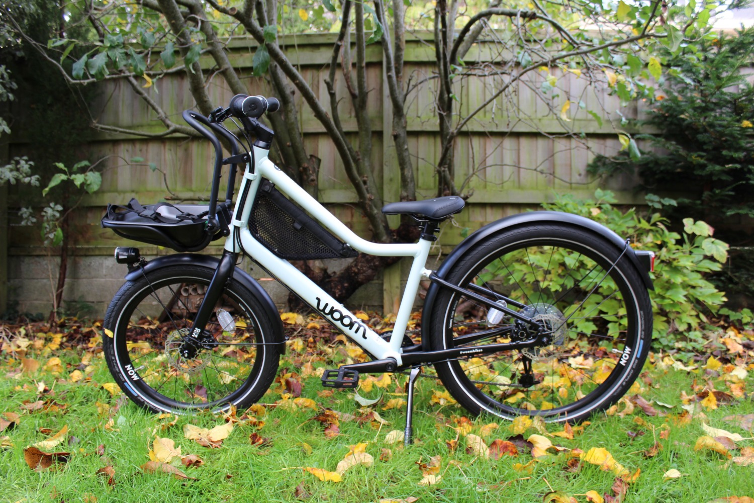 Woom NOW 5 kids urban bike - the review bike Cycle Sprog were sent to test side on on a patch of grass