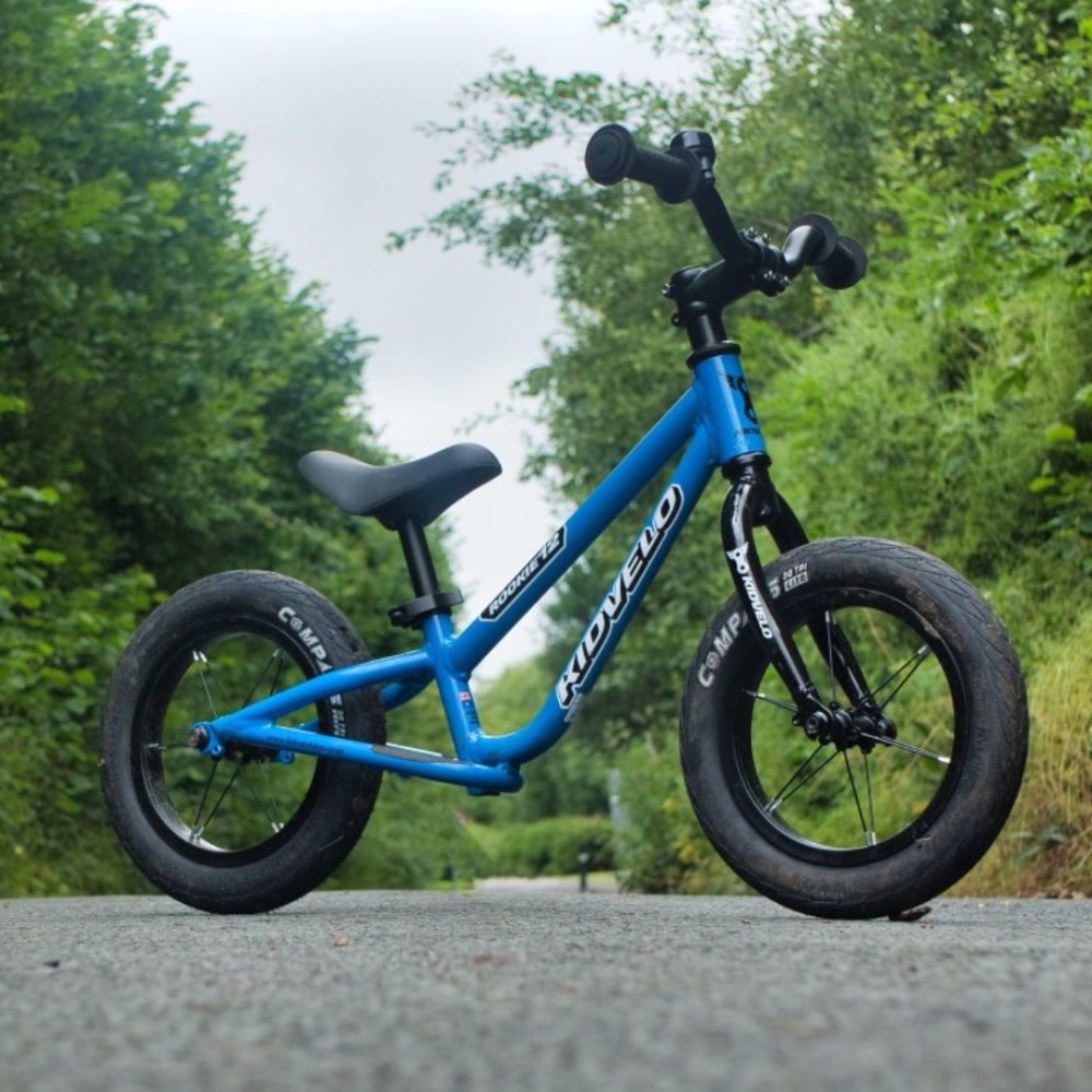 Best balance bikes: A Kidvelo Rookie 12 photographed on a path in front of some trees