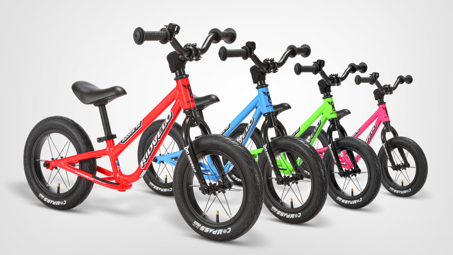 How to teach an autistic child to ride a bike: A lineup of Kidvelo balance bikes in different colours on a plain background