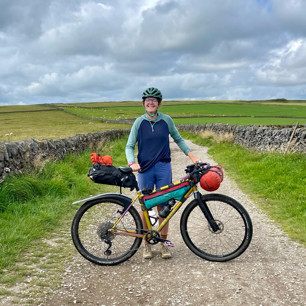 Emily Wormald standing on a gravel trail with her bike