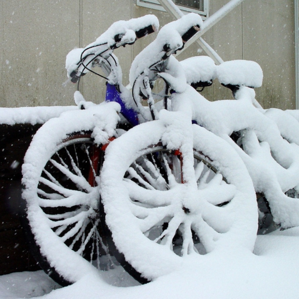 Winter cycling with kids: Two bikes left outside overnight, now covered in snow