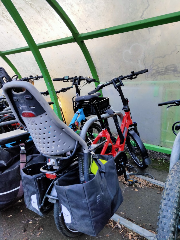 Midtail cargo bike locked up to stand