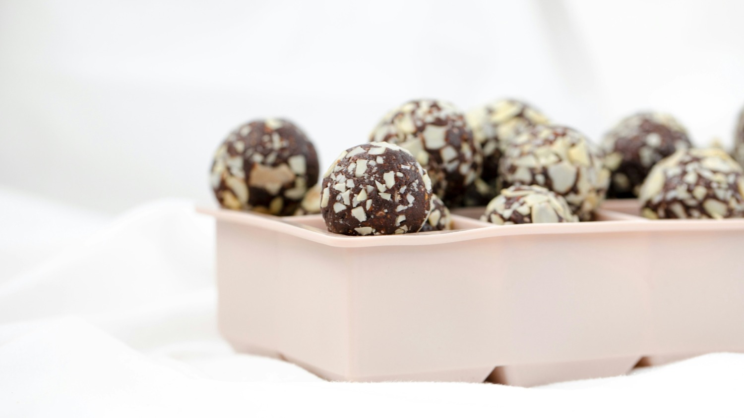 Cycling in Ramadan - a pink ice cube tray with date energy balls piled on top