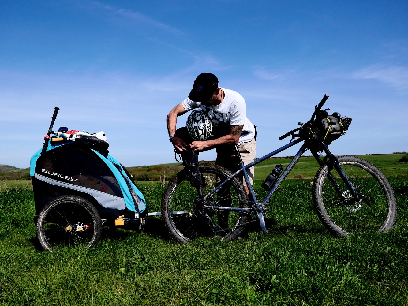 Benefits of hiring for your family cycling holiday, dad packing his bags bikepacking with a trailer