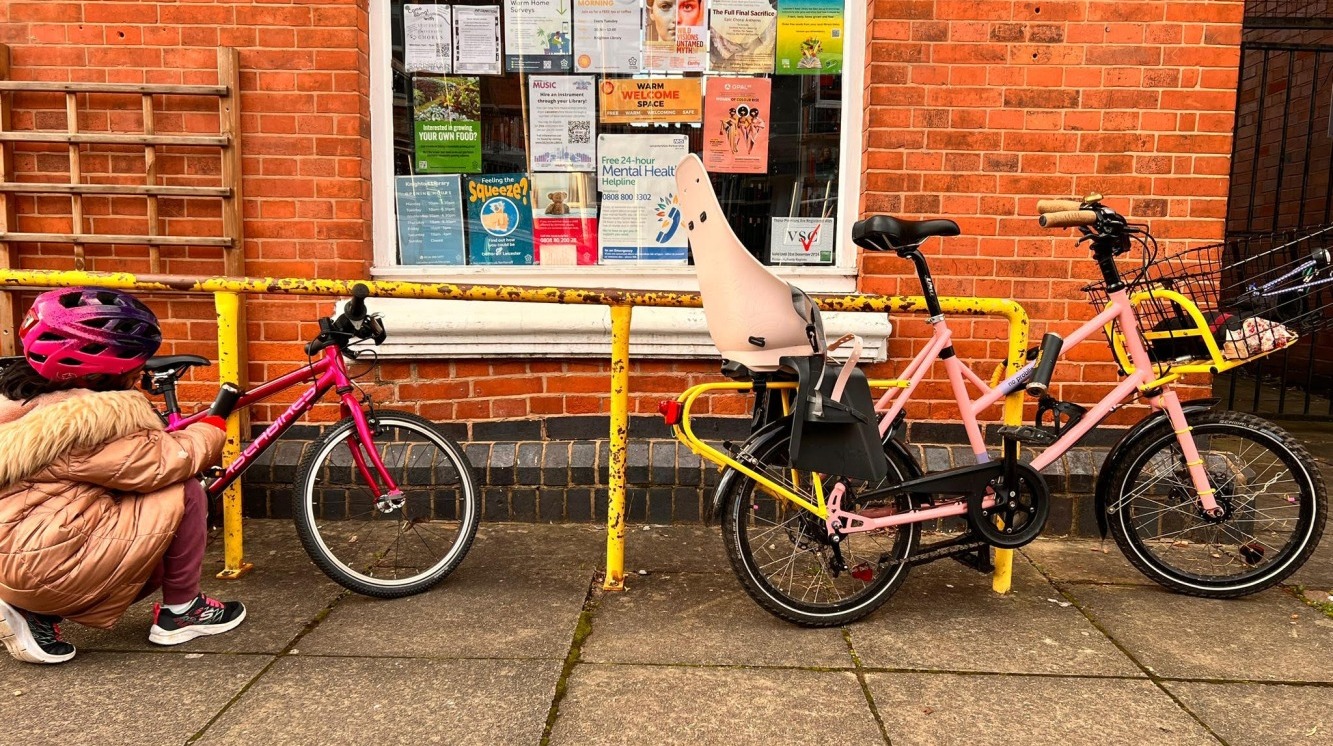 Cycling in Ramadan - Sarah's cargo bike and her daughter's Islabike locked up to a railing outside their local library