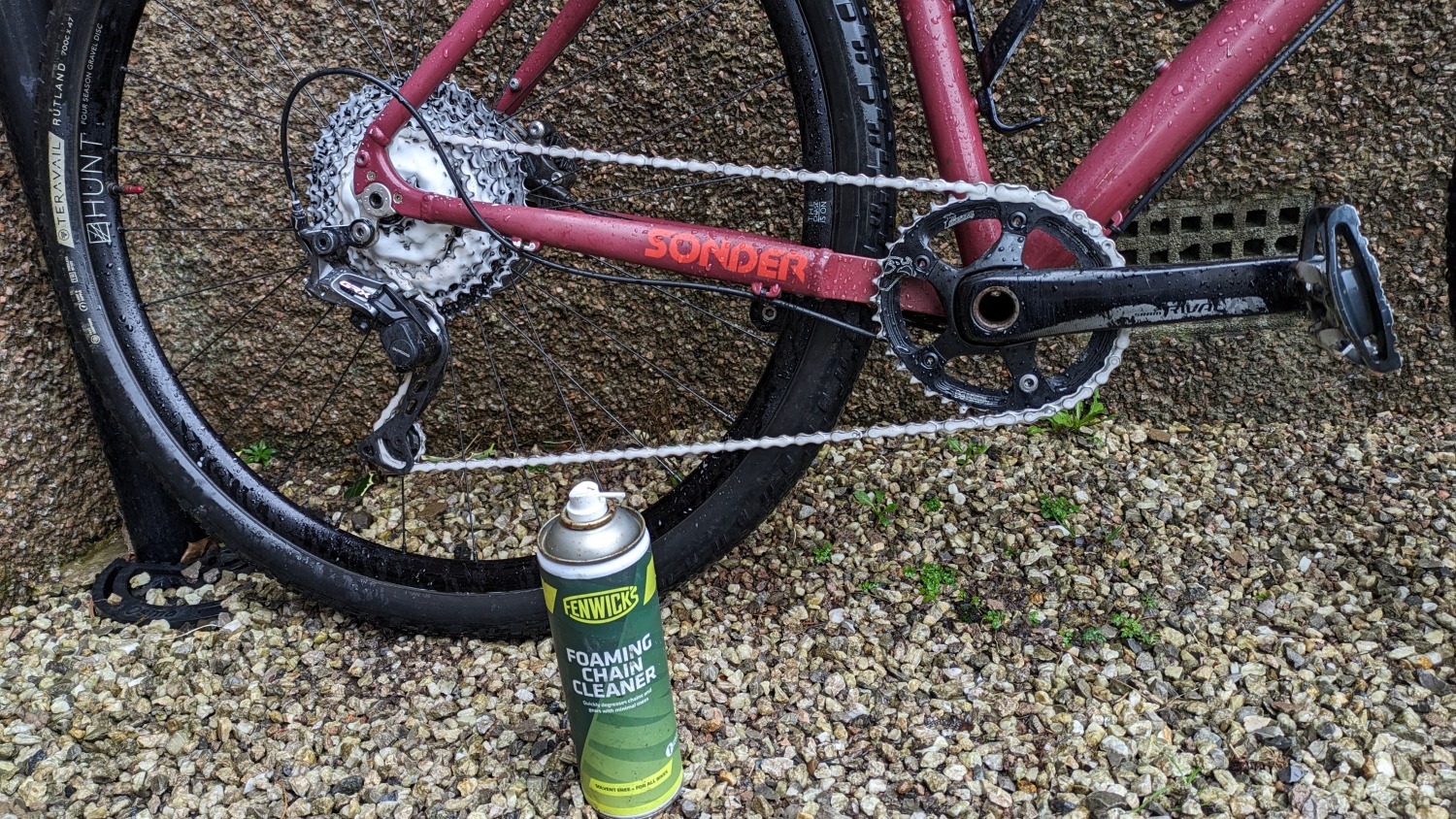 Fenwicks foaming chain cleaner on a red bike.