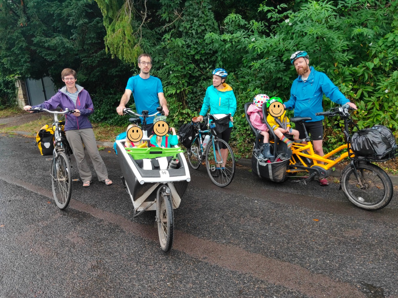 Two families on four bikes, including 1 longtail bike, 1 box bike.