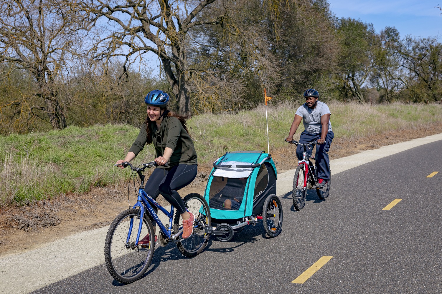 Benefits of hiring for your family cycling holiday, two parents on a family bike ride