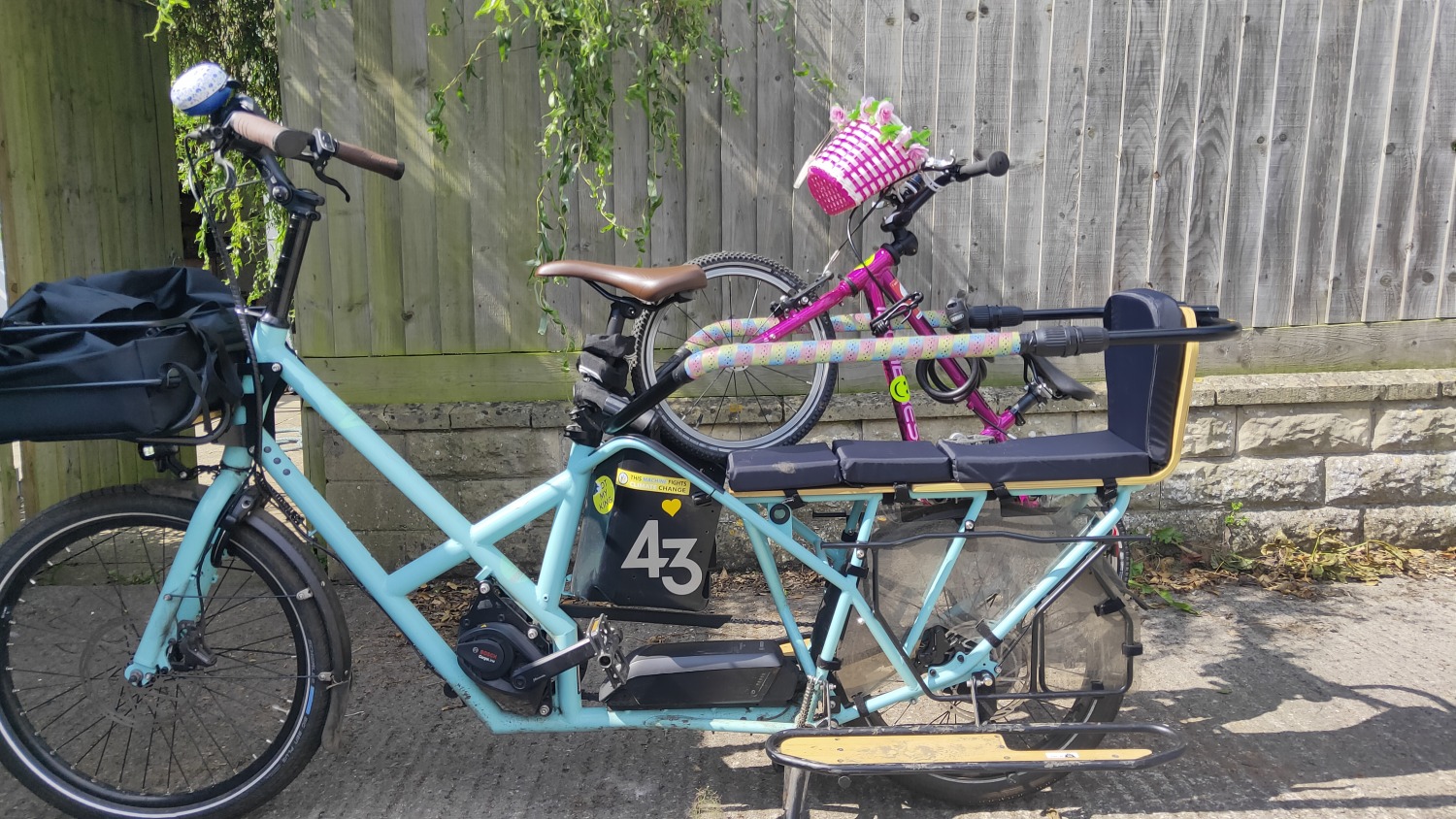 Longtail bike with child's bike attached to the rear