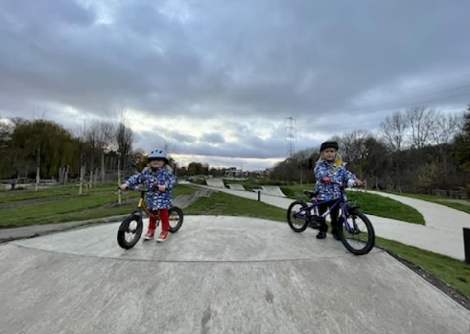 two children riding a pump track