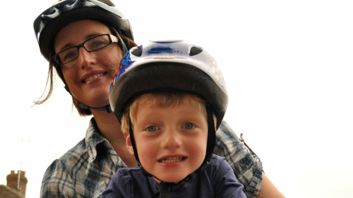 A front view of Karen Gee and her small son, in a front-mounted bike seat
