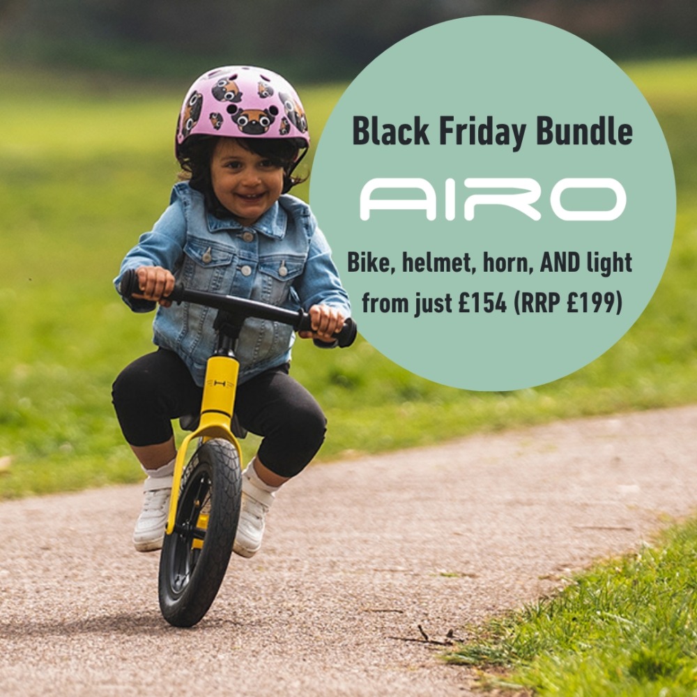 Hornit Black Friday deal: A photo of a toddler riding a Hornit balance bike, with a badge in the middle stating their AIRO bundle deal: Get an AIRO balance bike + a helmet + a MINI bike horn + a TRACE rear light from just £154 (RRP from £199)