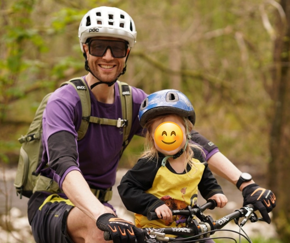 Kids Ride Shotgun seat review, daughter in a yellow top with her dad in the forest