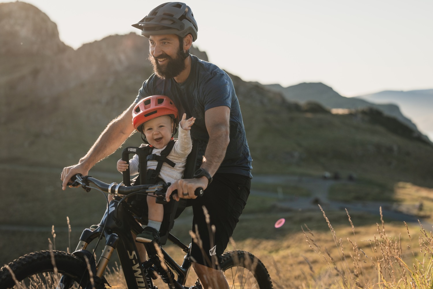 a stock image of a dad and son riding the kids ride shotgun pro evo on a sunny day