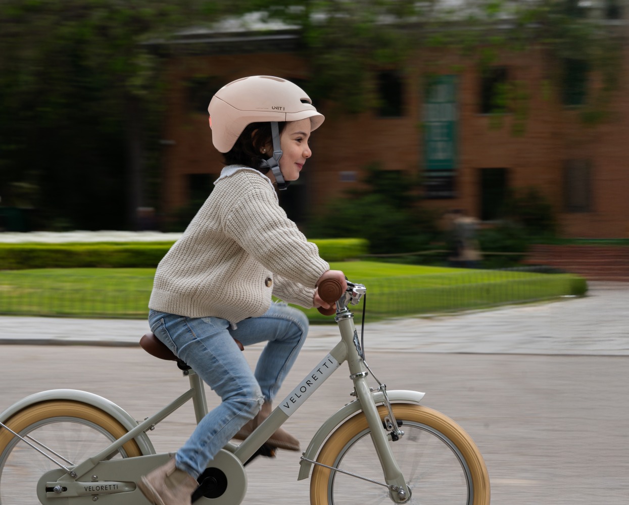 Girl riding her bike wearing a SPARKY helmet