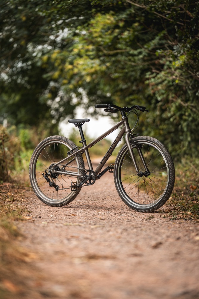 The Hornit HERO 24 standing alone on a gravel path with trees in the background