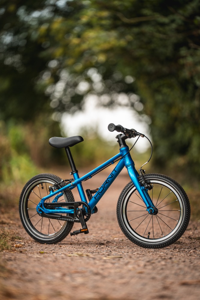 The Hornit HERO 16 standing alone on a gravel path with trees in the background