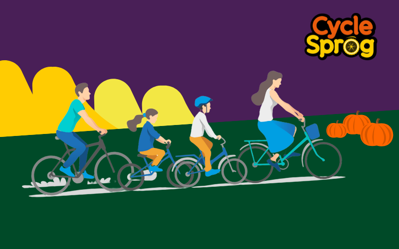 A cartoon graphic of a family riding bikes on a grassy hill with pumpkins and the Cycle Sprog logo