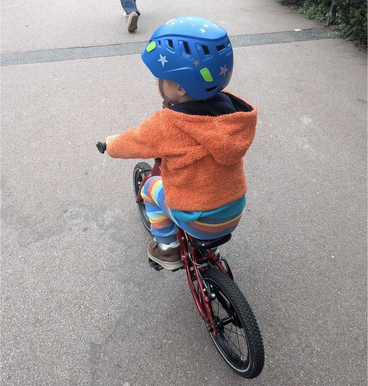 Hornit HERO 14 kids bike being ridden on pavement by a young boy in a blue helmet