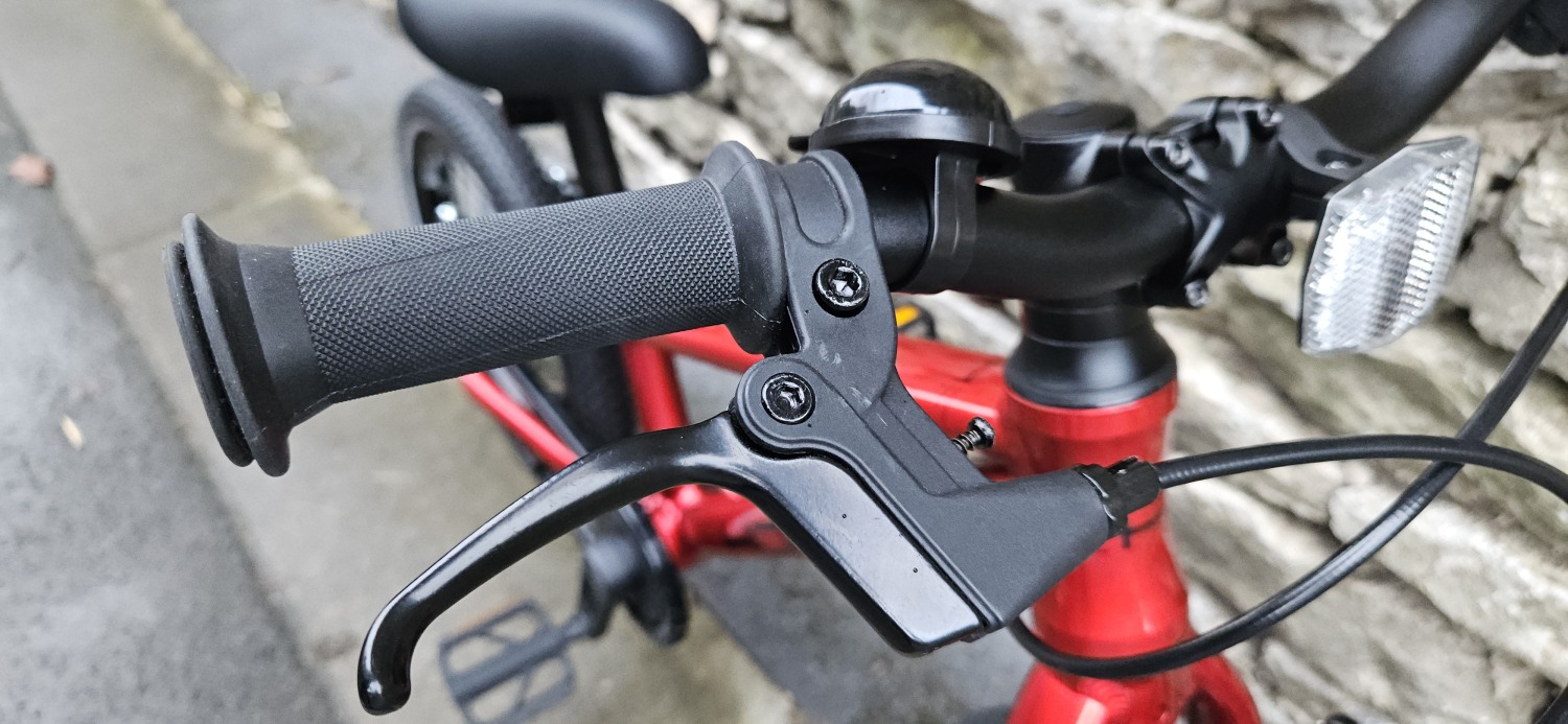 Red Hornit HERO 14 kids bike showing the handlebar and brake lever up close