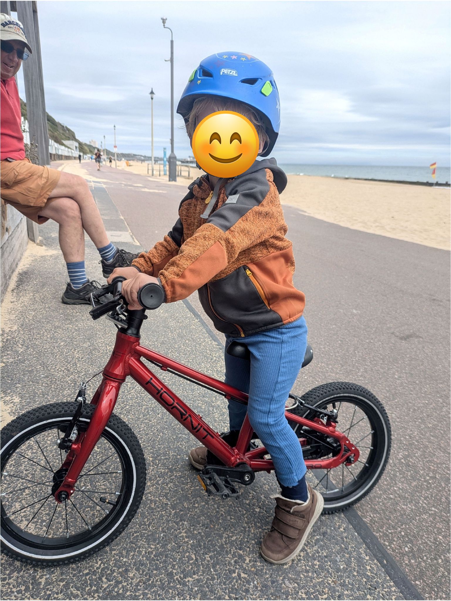 A young boy riding the Hornit HERO 14 kids bike in red