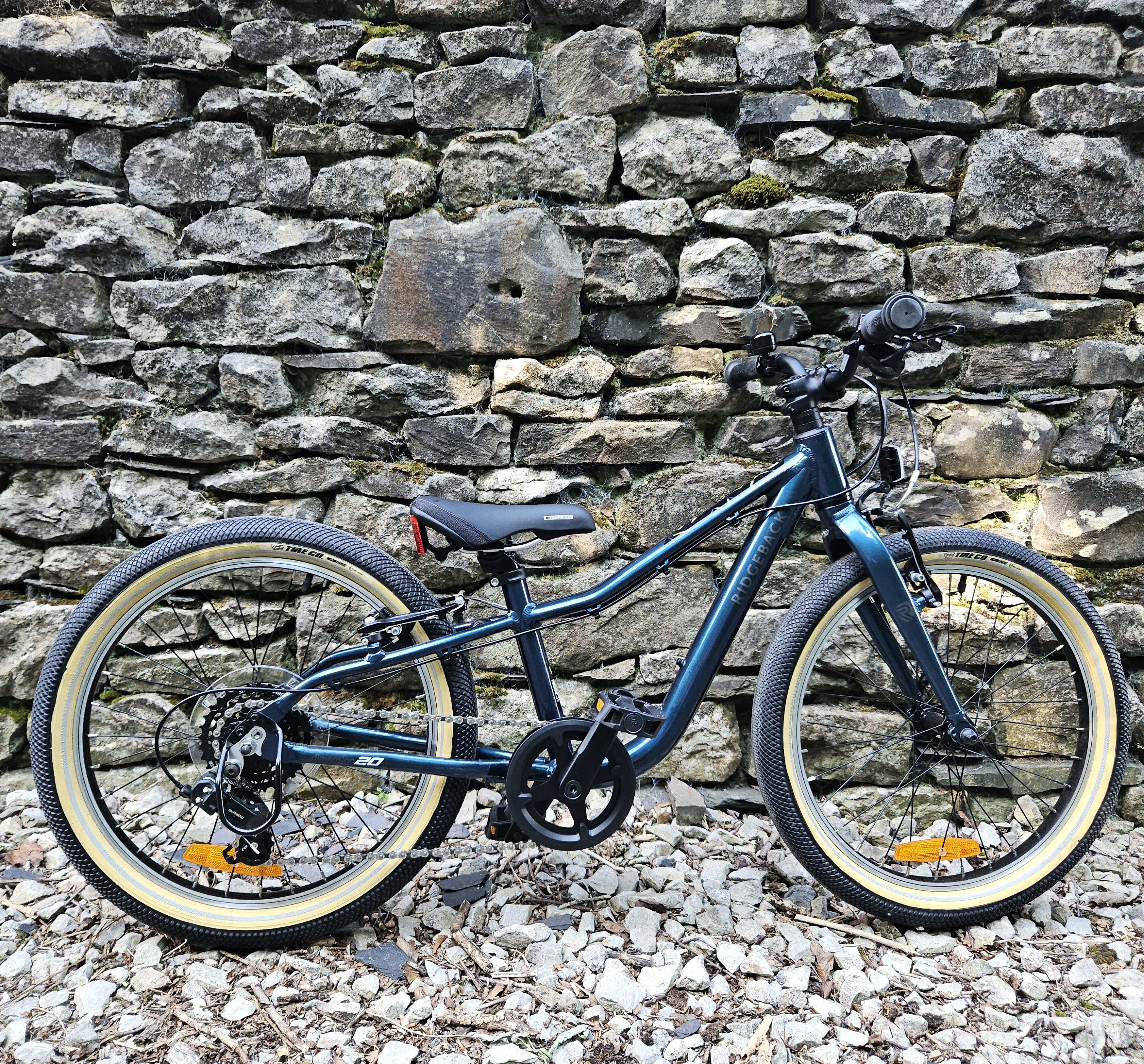 Ridgeback Dimension 20 kids bike leant against a wall
