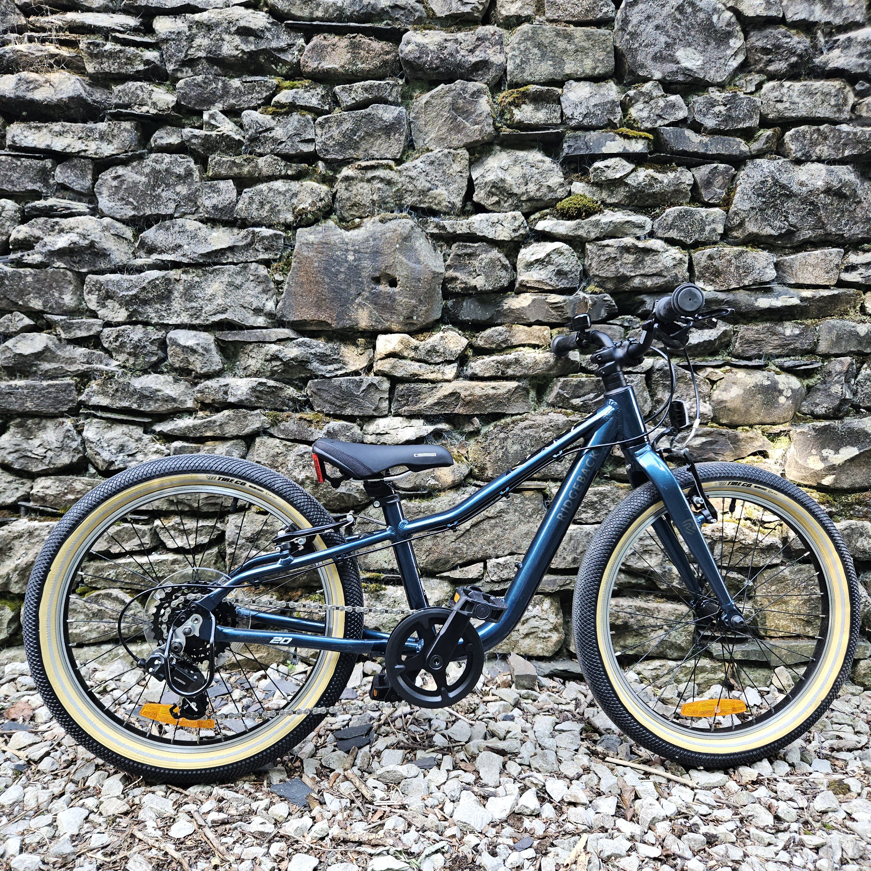 Ridgeback Dimension 20 kids bike leant against a wall