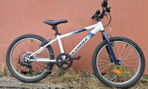 Rockrider 120 kids bike leant against a wall