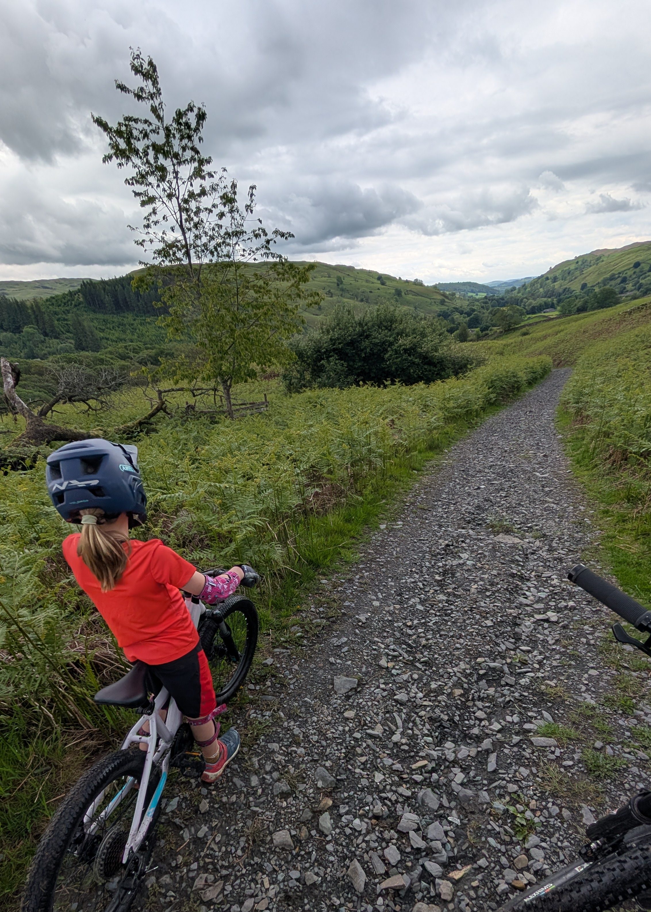 Shyre Eastie 20 kids bike being ridden along a gravel track in Cumbria