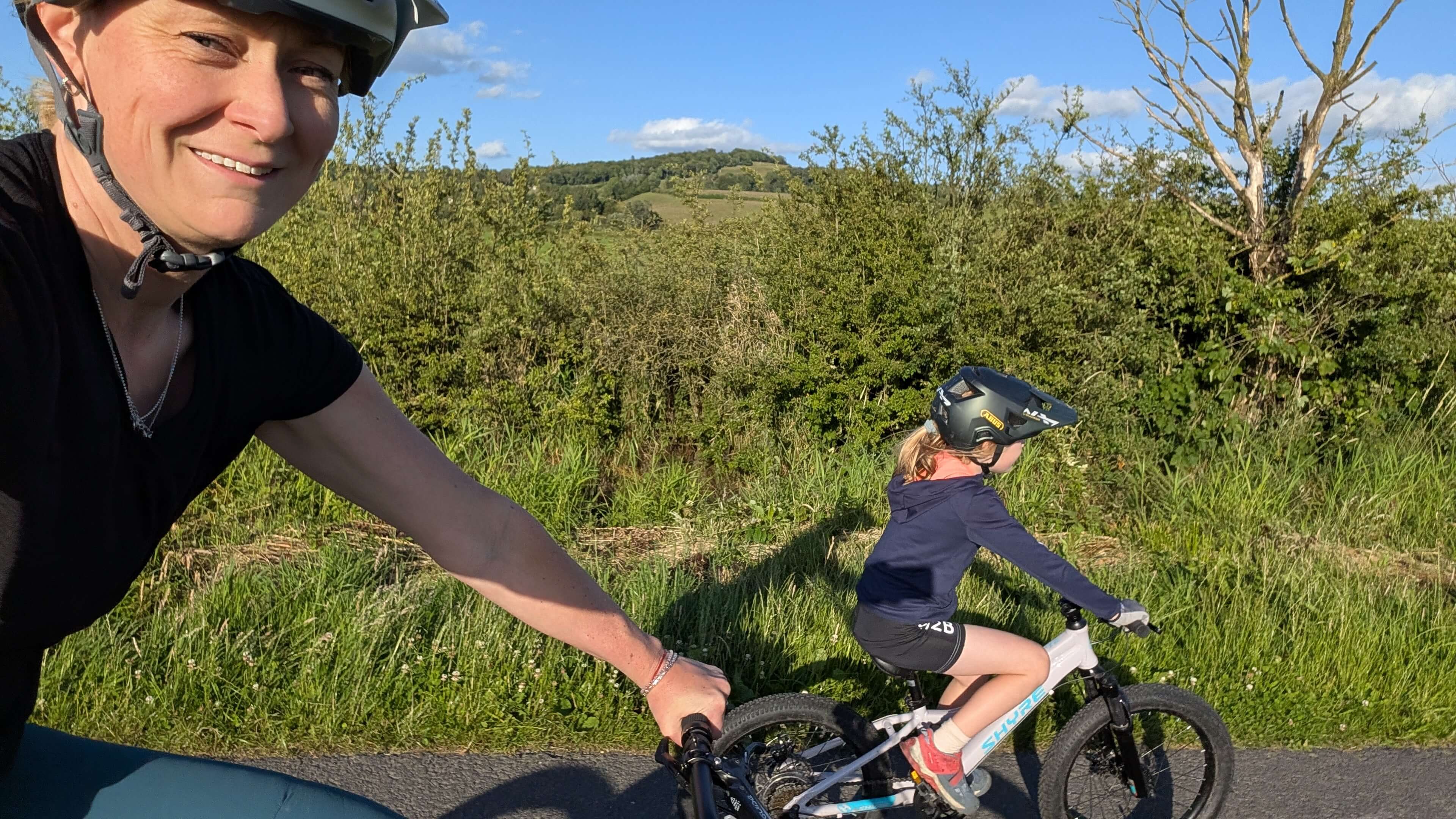 Mum and daughter cycling along a country road - the daughter is riding the Shyre Eastie 20 kids bike