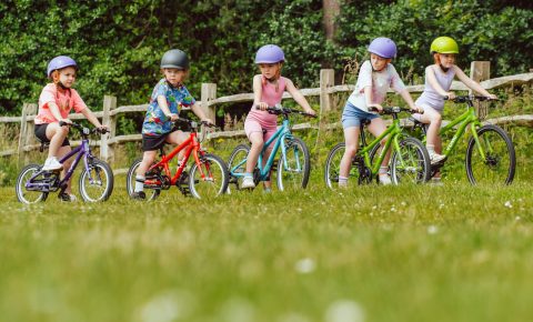 Group of 5 kids riding Yomo kids bikes in different colours