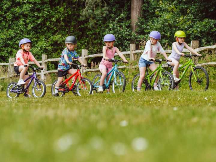 Group of 5 kids riding Yomo kids bikes in different colours
