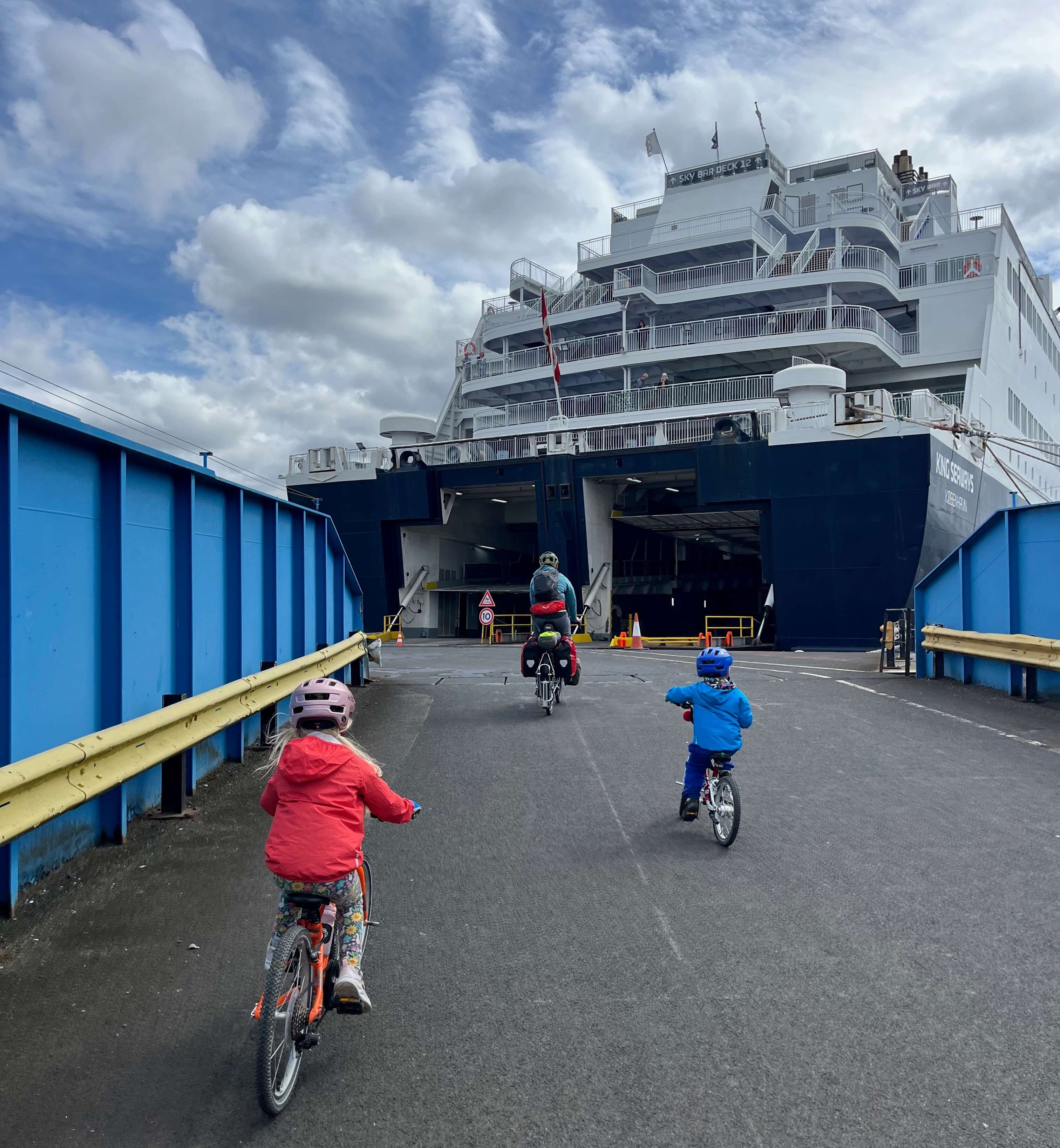 Family cycling onto a ferry in Newcastle to go on a cycling holiday in the Netherlands